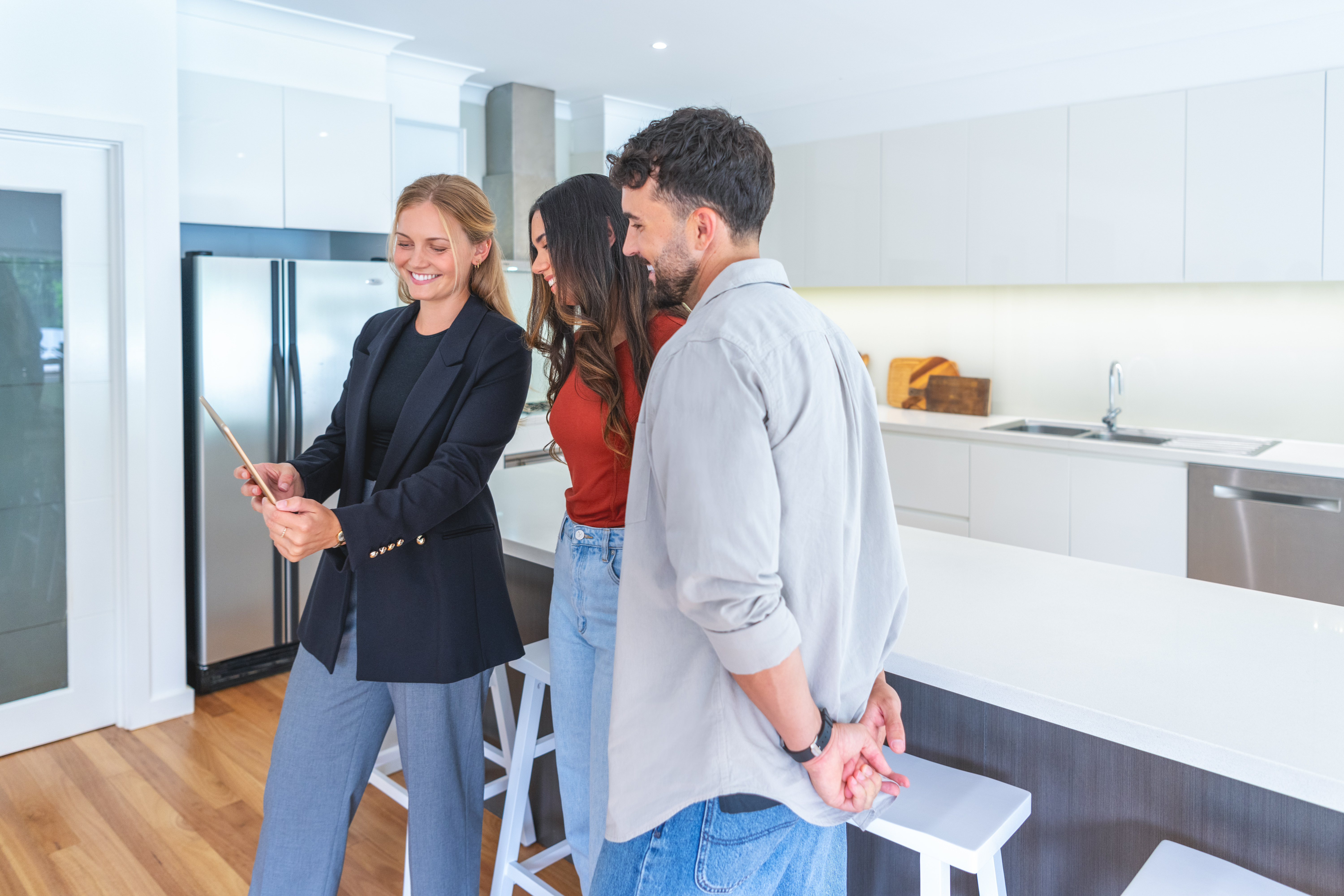 A Lynch inventory clerk showing a report to clients in a London kitchen